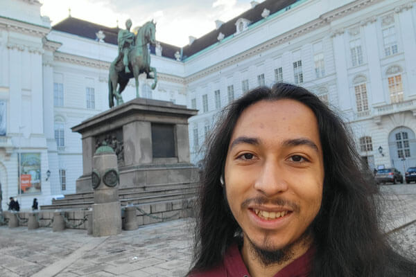 TRIO student takes a selfie in front of a statue.