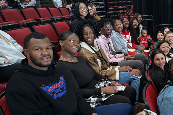 TRIO students seated at a basketball game.