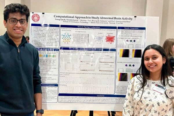 TRIO students pose next to their research poster at the Research Symposium.